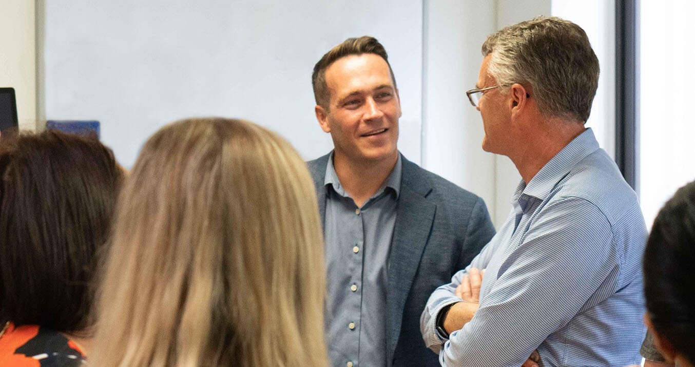 news - Two Office 365 consultants in discussion at a Microsoft meeting