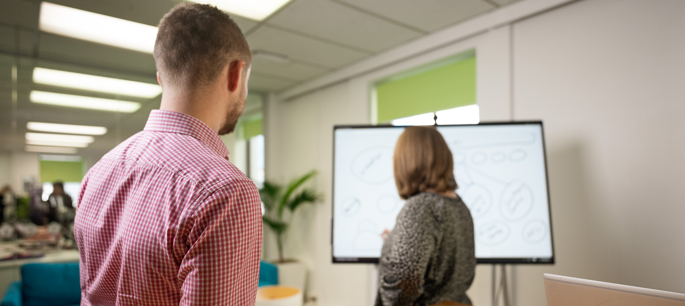 two people at surface hub adjusted for tile thumb 2023 03 15